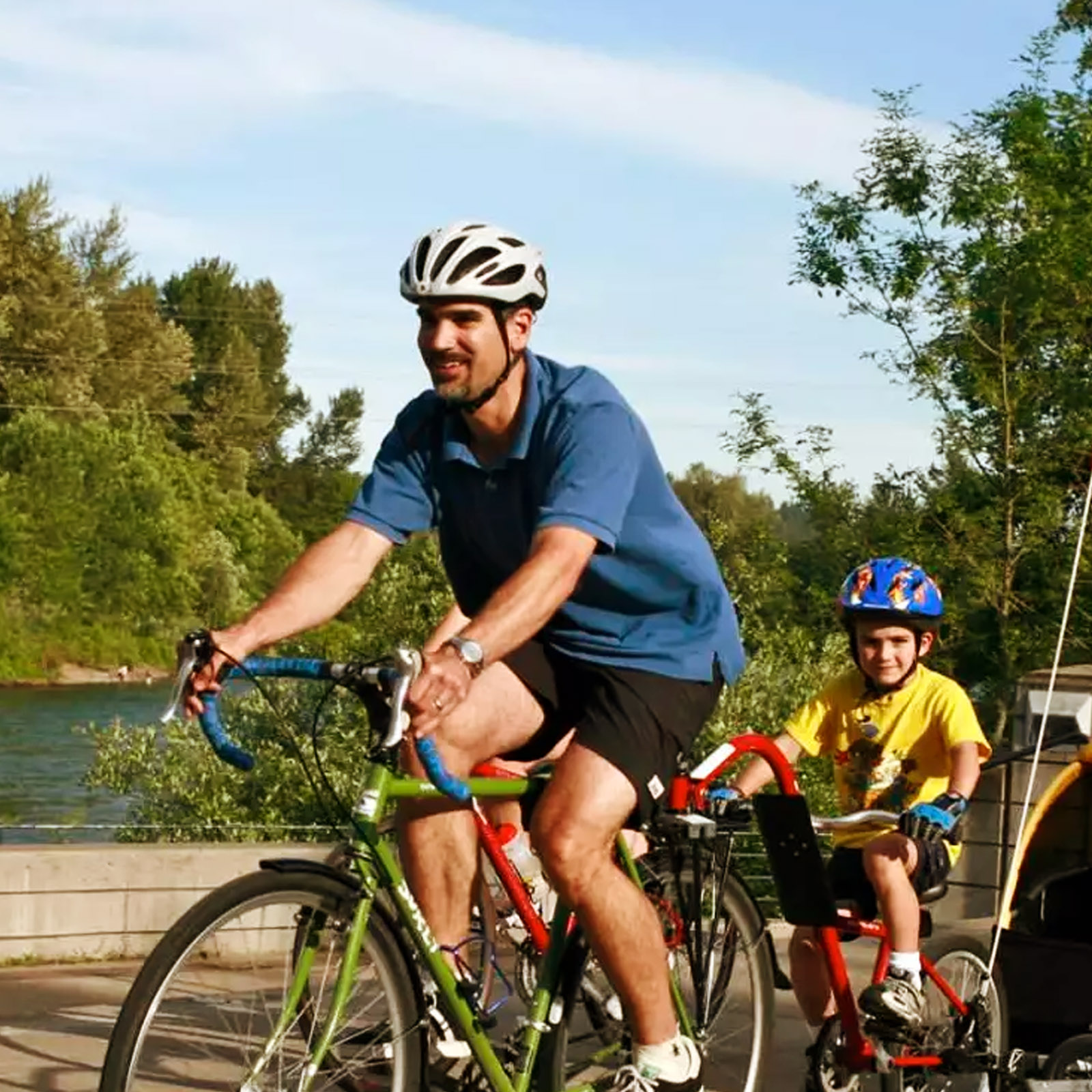 Man on a bike with children in tow